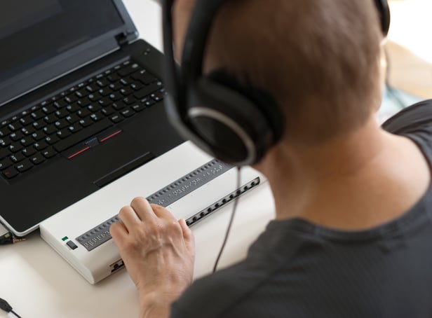 <p>Global Accessibility Awareness Day focuses on digital access and inclusion for people with disabilities or impairments. (Image shows visually impaired person working on computer with assistive technology) </p>