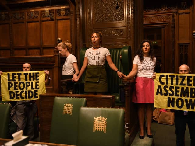 Handout photo taken with permission from the twitter feed of Extinction Rebellion of protesters who have superglued themselves around the Speaker's chair in the House of Commons chamber, as they call for a Citizen's Assembly. Picture date: Friday September 2, 2022.