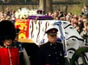 Soldiers accompany a gun carriage holding the coffin bearing the Queen Mother April 5, 2002.