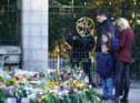 Members of the public look at floral tributes at Balmoral in Scotland following the death of Queen Elizabeth II on Thursday. Picture date: Saturday September 10, 2022. (Photo: PA)