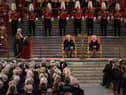 King Charles III and the Queen Consort listen to Speaker of the House of Lords Lord McFall of Alcluith (left) at Westminster Hall. Credit: PA