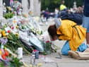 A woman is upset outside Buckingham Palace, London, following the death of Queen Elizabeth II on Thursday September 8, 2022. Picture date: Friday September 9, 2022.