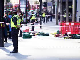 Police officers at the scene after three people have been taken to hospital following reports of stabbings at Bishopsgate in London. Picture date: Thursday October 6, 2022.