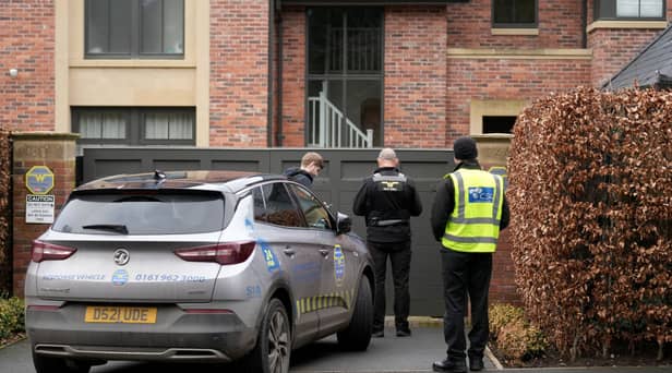 Police officers standing outside Mason Greenwood’s house in February 2022.