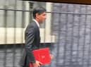 Rishi Sunak leaves Downing Street in 2020 with a burgundy coloured ring binder.