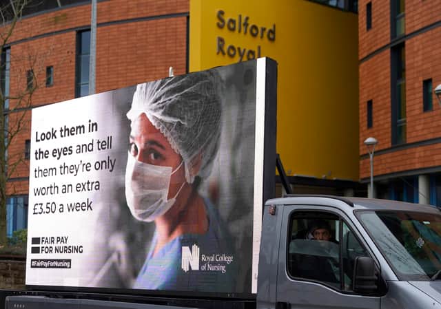 Responding to the government’s NHS pay proposal, the Royal College of Nursing has released a digital billboard message showing the image of a nurse in PPE with the message: ‘Look them in the eyes and tell them they’re only worth an extra £3.50 a week’ outside the Salford Royal hospital.