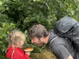 Jim Parums and his daugher foraging a mushroom - the family save £100 a week by foraging for all their meals. 