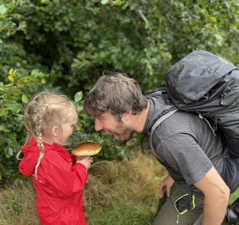 <p>Jim Parums and his daugher foraging a mushroom - the family save £100 a week by foraging for all their meals. </p>