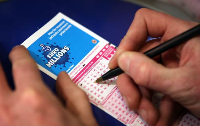  A punter fills out a National Lottery ticket.