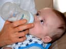 A baby drinks formula from a bottle. Pic: Pixabay.