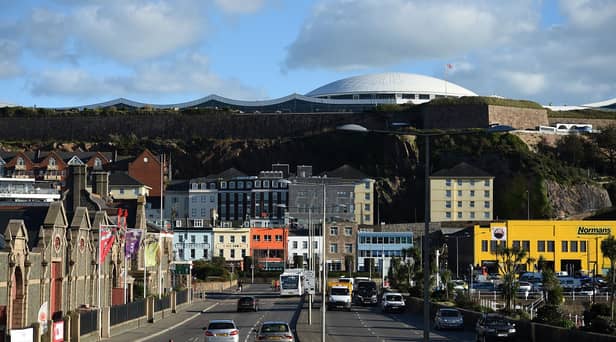 Cars travel by the seafront in St Helier, on the British island of Jersey