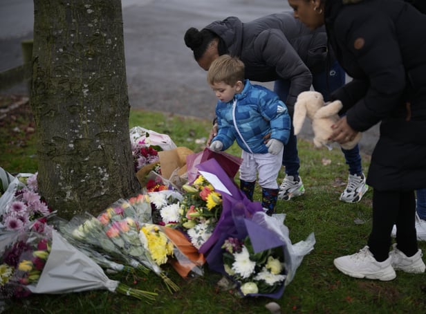 <p>Flowers are left near the scene after three young boys died when a number of children fell through ice on a lake in Solihull. </p>