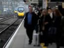 Passengers wait to board an Avanti West Coast mainline train at Crewe Station on December 01, 2022 in Crewe, England. The Rail, Maritime and Transport workers union (RMT) said its members will strike on eight days - December 13, 14, 16 and 17, and January 3, 4, 6 and 7 - the latest episode in a dispute over pay and working practices. (Photo by Christopher Furlong/Getty Images)