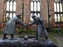 A resin model of a sculpture illustrating the WW1 Christmas Truce football match is pictured during a photocall inside the remains of St Luke's Church in Liverpool