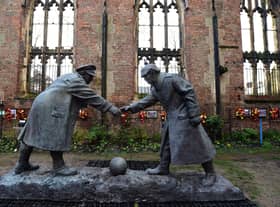 A resin model of a sculpture illustrating the WW1 Christmas Truce football match is pictured during a photocall inside the remains of St Luke's Church in Liverpool