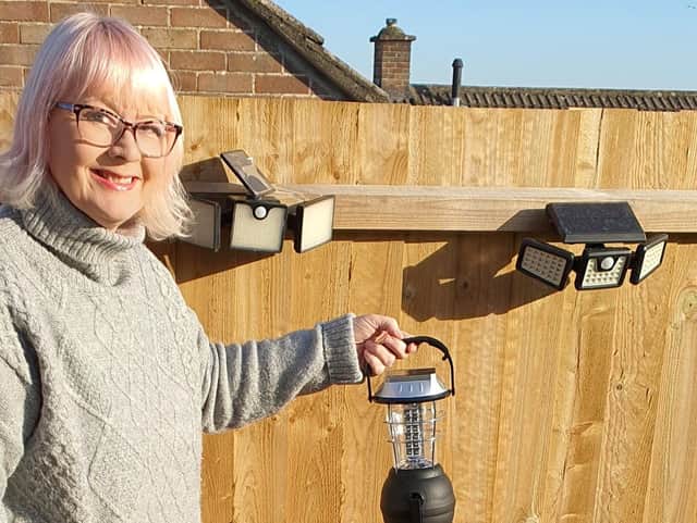 Kerry Collinson with a solar light and her foldable solar panel. 