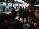 Commuters wait for an extremely delayed Central Line train at Stratford station in London on December 13  as rail strikes began a wave of festive walkouts in the country.