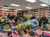 Reese, far right, and his team with some of hundreds of toys they bough from Smyth's Toy Shop