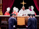 Pope Francis attends the funeral mass for Pope Emeritus Benedict XVI as pallbearers carry the coffin at the end of the funeral mass at St. Peter's square