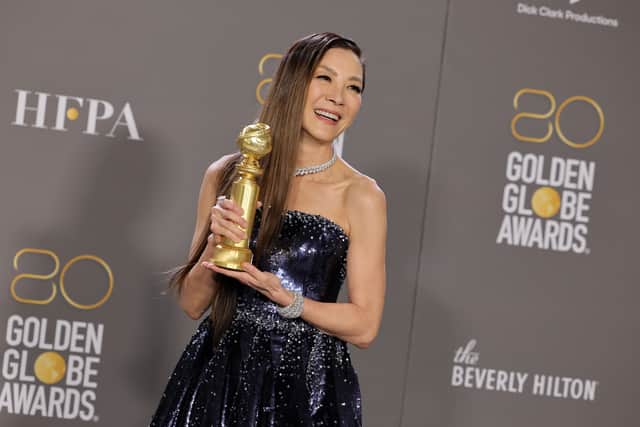 Michelle Yeoh poses with the Best Actress in a Motion Picture â Musical or Comedy award for "Everything Everywhere All at Once"