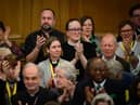 : Members of the General Synod react after blessings for same-sex couples was approved in a vote by the General Synod at The Church House.