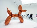 A woman accidentally destroyed a Jeff Koons glass sculpture believing it to be a balloon dog.