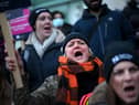 Striking nurses hold signs at a picket line outside University College Hospital in London on January 19, 2023.
