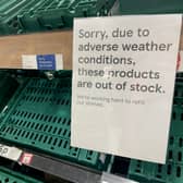 Empty shelves are seen in the fruit and vegetable aisles of a Tesco supermarket on February 22 in Burgess Hill.