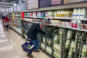 A customer shops for milk inside a Sainsbury's supermarket in east London on February 20, 2023.