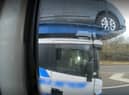 Footage shows the driver using his elbow to control the car transporter (Photo: Highways England) 