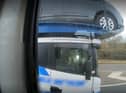 Police officers overtaking a heavily-laden car transporter were shocked to discover the driver was using just one elbow to control the huge vehicle as he travelled along a busy motorway. 