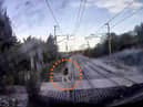 The video shows a man just inches from being hit by the speeding train.
