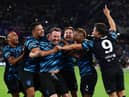 Lee Mack celebrates his goal with World XI teammates including Steven Bartlett (left-centre)