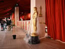 A bucket collects water leaking from the ceiling as rain from a winter storm falls on the not so red carpet arrivals area, ahead of the 95th Academy Awards, in Hollywood, California, on March 10, 2023.