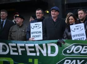 RMT general secretary Mick Lynch (centre) on an RMT picket line during January’s strike (Photo by DANIEL LEAL/AFP via Getty Images)