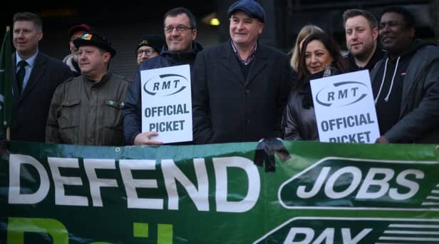 RMT general secretary Mick Lynch (centre) on an RMT picket line during January’s strike (Photo by DANIEL LEAL/AFP via Getty Images)