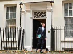 Britain's Chancellor of the Exchequer Jeremy Hunt walks out of Number 11 Downing Street 