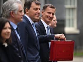 Britain’s Chancellor of the Exchequer Jeremy Hunt poses with the red Budget Box as he leaves 11 Downing Street in central London on March 15, 2023, to present the government’s annual budget to Parliament. (Photo by JUSTIN TALLIS / AFP) (Photo by JUSTIN TALLIS/AFP via Getty Images)