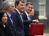 Britain’s Chancellor of the Exchequer Jeremy Hunt poses with the red Budget Box as he leaves 11 Downing Street in central London on March 15, 2023, to present the government’s annual budget to Parliament. (Photo by JUSTIN TALLIS / AFP) (Photo by JUSTIN TALLIS/AFP via Getty Images)