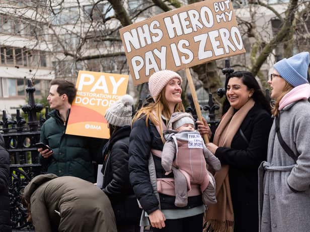 Demonstrators hold placards as they take part in a protest by junior doctors. Picture: NIKLAS HALLE’N/AFP via Getty Images