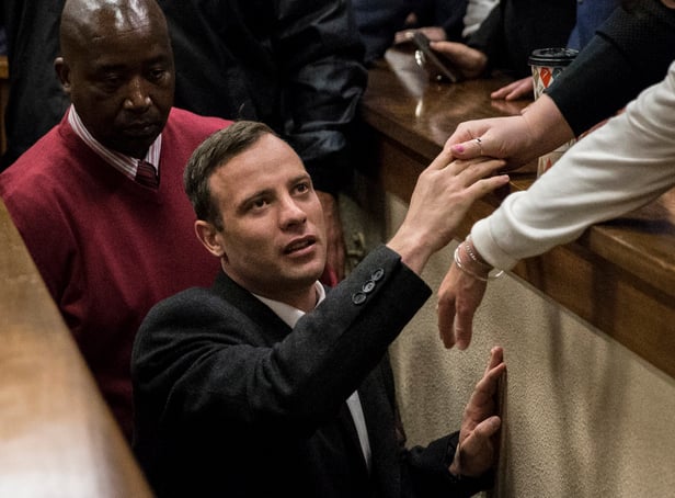 <p>Olympic athlete Oscar Pistorius holds the hand of a relative after sentencing at the High Court on July 6, 2016 at the High Court in Pretoria, South Africa. Pistorius was sentenced to six years in prison for the murder of girlfriend Reeva Steenkamp at their home in 2013.</p>