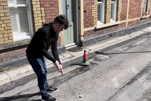 Ben Thornbury demonstrating 'crazy pothole golf' in Malmesbury