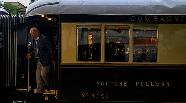 A man disembarks from the Venice Simplon-Orient-Express after arriving at Istanbul Station in Istanbul (Photo by YASIN AKGUL/AFP via Getty Images)