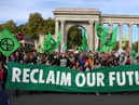 Protesters march into central London at a demonstration by the climate change protest group Extinction Rebellion, on October 16, 2022. Credit: Isabel Infantes/AFP.