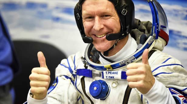 Britain's astronaut Tim Peake gestures as his space suit is tested at the Russian-leased Baikonur cosmodrome (photo: Getty Images)