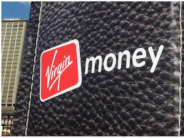 British entrepreneur Richard Branson walks out of a giant wallet as he launches Virgin Money's new credit cards in Sydney Harbour on July 27, 2010. The financial services arm of Branson's Virgin Group now offers Australians low interest rate credit cards, savings accounts, superannuation and car insurance. AFP PHOTO / Torsten BLACKWOOD (Photo by TORSTEN BLACKWOOD / AFP) (Photo by TORSTEN BLACKWOOD/AFP via Getty Images)
