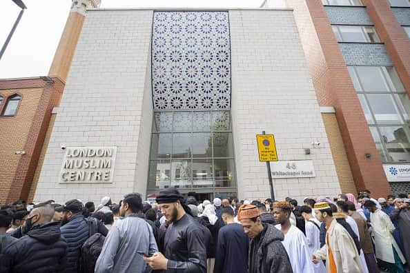 Muslims gather to perform Eid al-Fitr prayer at East London Mosque in London last year. (Photo by Rasid Necati Aslim/Anadolu Agency via Getty Images)