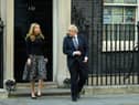 Prime Minister Boris Johnson and his partner Carrie Symonds stand outside the door of number 10 Downing Street (Photo by Leon Neal/Getty Images)