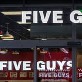 Five Guys reveals why they give customers extra fries & unlimited toppings with every order