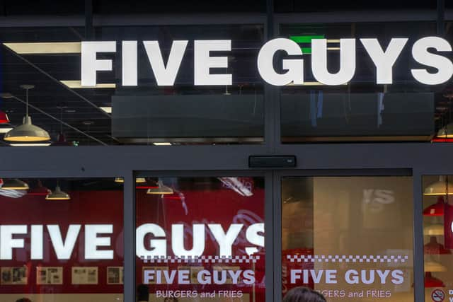 Five Guys reveals why they give customers extra fries & unlimited toppings with every order